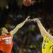 Michigan freshman Spike Albrecht hits a three-pointer over Syracuse senior Brandon Triche in the Final Four in Atlanta on Saturday, April 6, 2013. Melanie Maxwell I AnnArbor.com